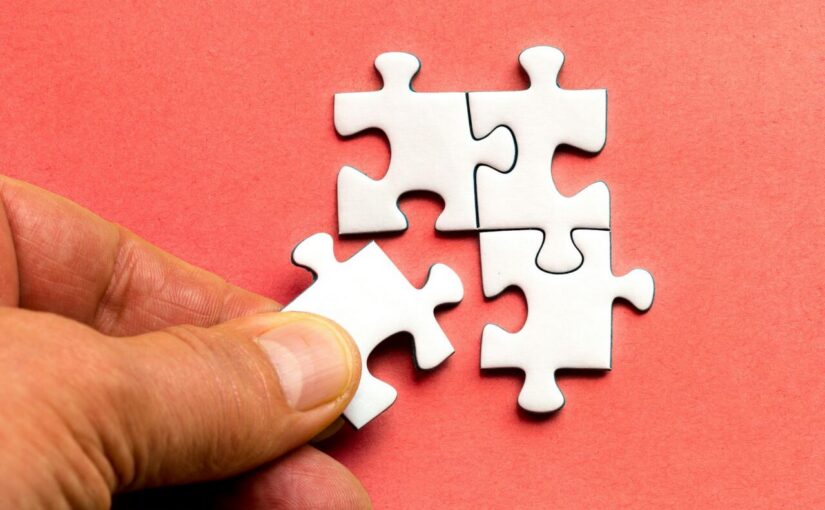 white puzzle pieces on red textile