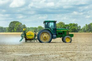 green and yellow tractor on dirt