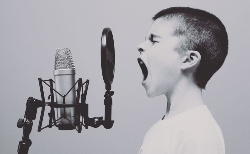 Boy shouting into microphone