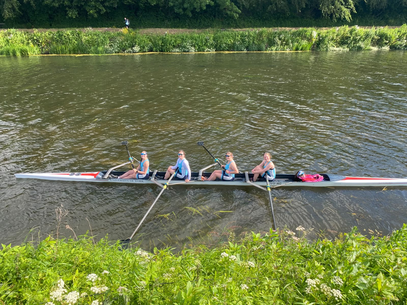 Robin in a row boat with three students.